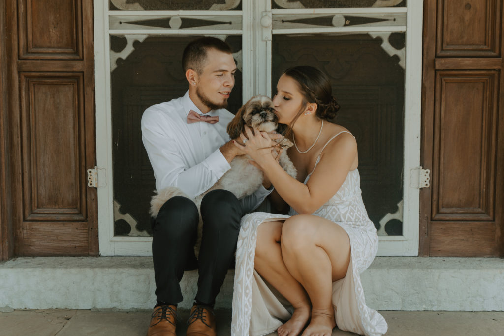 Dog with bride and groom on the wedding day.